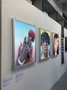 Fashion Subcultures images of three men modelling. Presented in three light boxes on a wall.